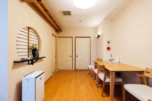 a dining room with a table and chairs at Just a short walk 心斎橋 Glico Sign 1min 道頓堀30-second 黒門市場 難波駅 Dotonbori Guesthouse 兰の阁 in Osaka