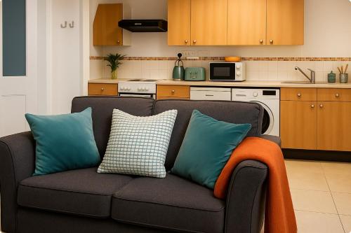 a couch with pillows on it in a kitchen at The Little Nest in Colchester in Colchester