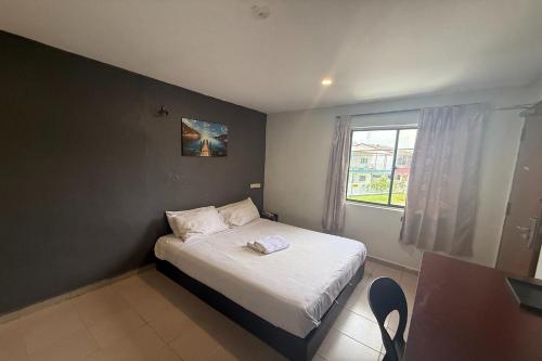 Ένα ή περισσότερα κρεβάτια σε δωμάτιο στο Tiong Nam Hotel