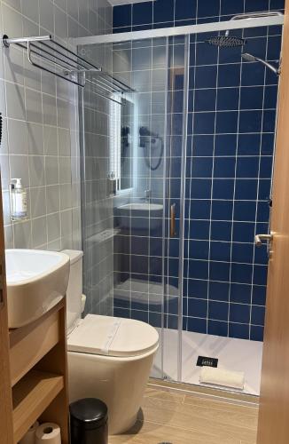 a bathroom with a toilet and a glass shower at Oporto Station Hostel & Rooms in Porto