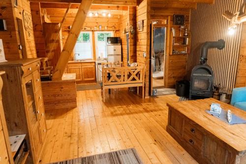 uma grande sala de estar com fogão em uma cabana de madeira em Alter Schwede em Südbrookmerland