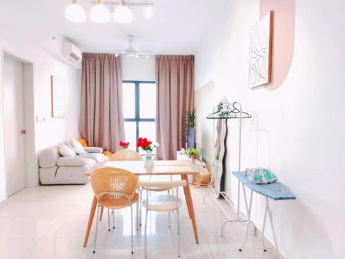 a white living room with a table and chairs at TRION-KUALA Lumpur Near By TRX in Kuala Lumpur