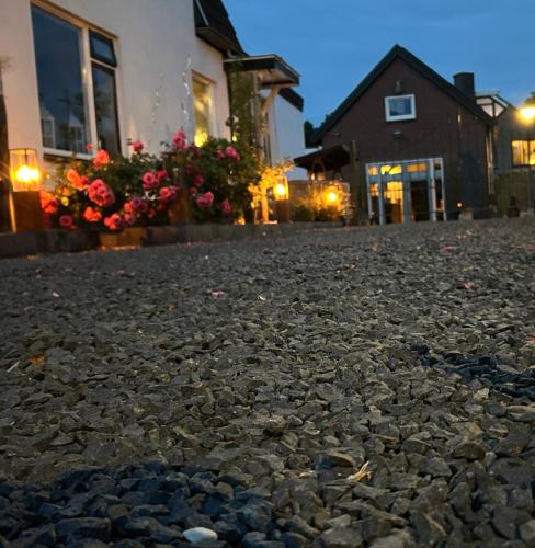 a cobblestone street in front of a house at B & B Huize Hertog met Whirlpool in Apeldoorn