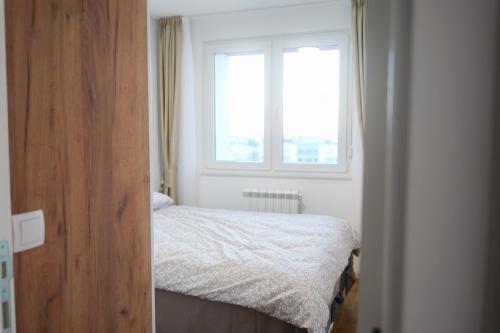 Postel nebo postele na pokoji v ubytování Apartment Lumora