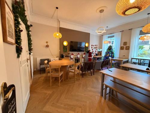 un comedor con mesas y sillas y un árbol de Navidad en 16 Pilrig Guest House, en Edimburgo