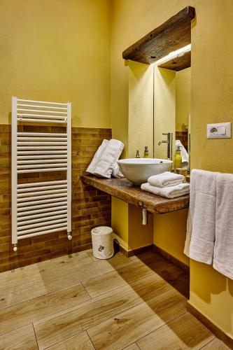 a bathroom with a sink and a mirror at Foresteria Castello di Verrazzano in Greve in Chianti