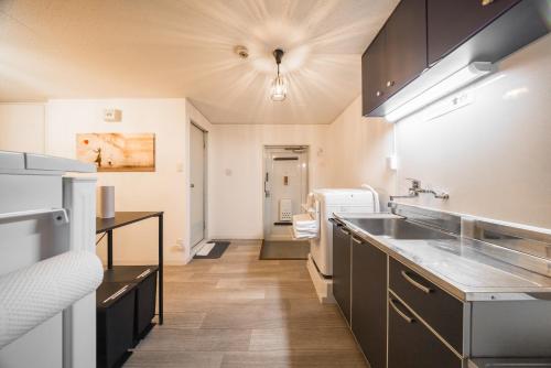 a kitchen with a sink and a counter top at mikiHOTEL本川町303 in Hiroshima