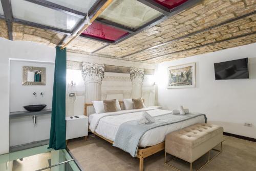 a large bedroom with a large bed and a sink at DrsRome - Colosseum Loft in Rome