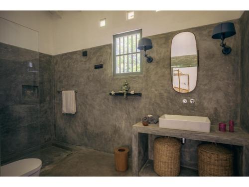 a bathroom with a sink and a surfboard on the wall at Dutch house 5 bedrms pool chef in Habaraduwa Central