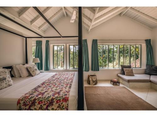a large bedroom with a large bed and windows at Wijaya Giri walkable to beach pool chef in Ahangama