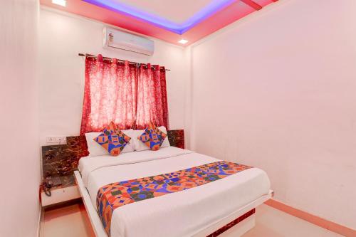 a small bedroom with a bed in a room at FabHotel Devi Residency Wakad in Pune