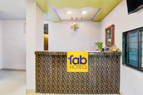 a hotel lobby with a sign on a counter at FabHotel Devi Residency Wakad in Pune