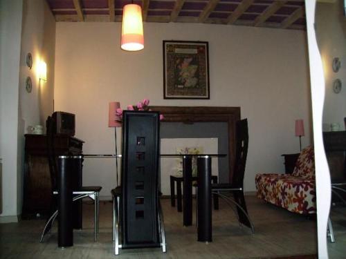 a living room with a table and chairs and a couch at Glicine in Miasino