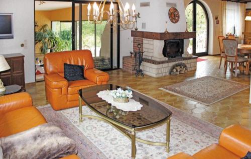 a living room with orange furniture and a fireplace at Ferienbungalow Anne in Wadern