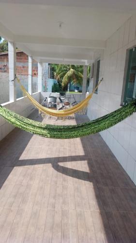 a hammock hanging from the side of a building at Refúgio Paris Cris & Val in Monte Gordo