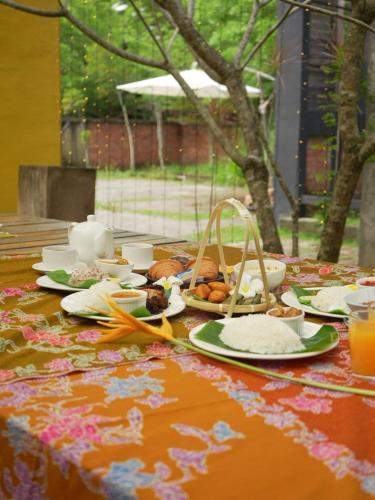 a table topped with plates of food and drinks at PCB The Seven Gardens Resort & Spa in Kota Bharu