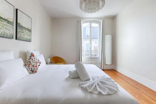 Ένα ή περισσότερα κρεβάτια σε δωμάτιο στο Appartements à Champigny-Sur-Marne - 30 minutes de Disneyland