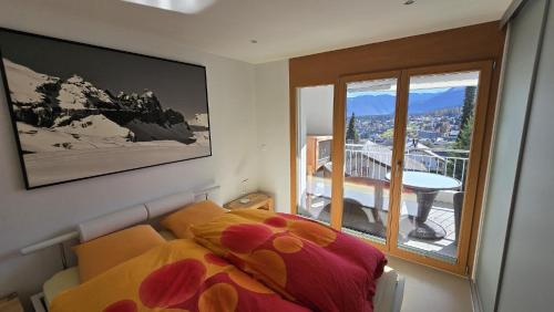 Ένα ή περισσότερα κρεβάτια σε δωμάτιο στο LAAX Homes-Casa Joerger