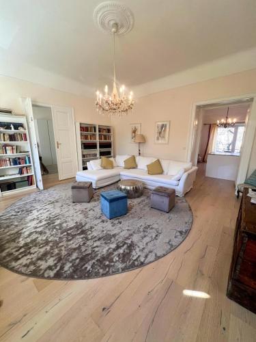 a living room with a couch and a rug at Altstadt Elegance in Graz Ostbahnhof