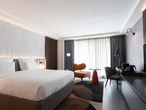 Ένα ή περισσότερα κρεβάτια σε δωμάτιο στο Pullman Kinshasa Grand Hotel