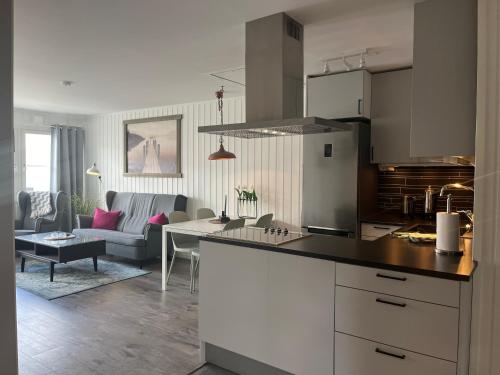 a kitchen and living room with a couch and a table at Åre Stay- Åregårdarna 426 in Åre