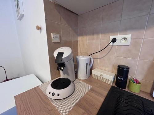 a white mixer sitting on a counter in a kitchen at Le Petit Cocon de Pleyben in Pleyben