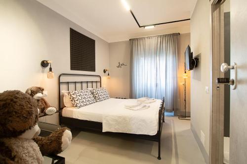 a bedroom with a bed and a teddy bear in a chair at Residenza Tor Vergata 2025 in Rome