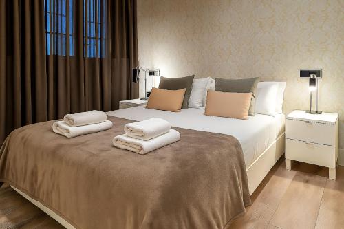a bedroom with a bed with towels on it at Habitat Apartments Paseo de Gracia in Barcelona