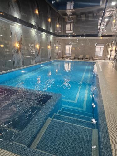 a large indoor swimming pool in a building at Zamin Hotel in Zomin
