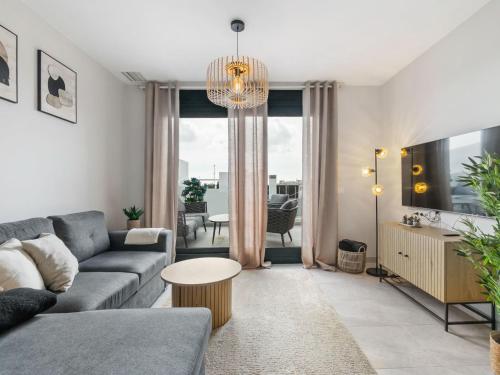 a living room with a couch and a table at Apartment Aire Residencial by Interhome in Villacosta