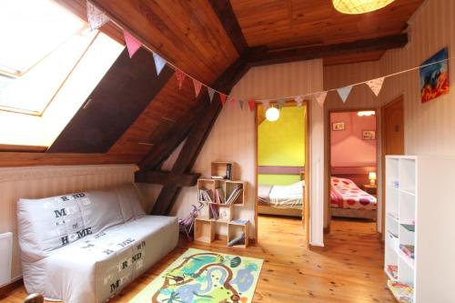 a bedroom with two beds and a room with a ceiling at Le lheze in Cette-Eygun