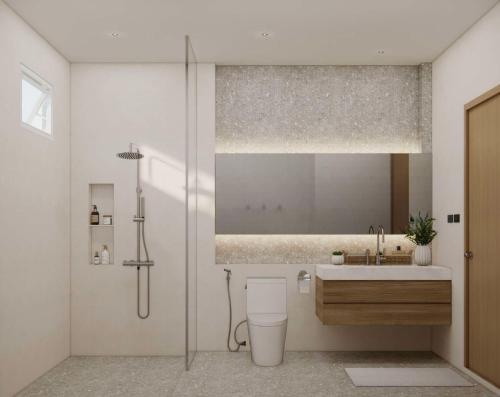 a bathroom with a shower and a toilet and a sink at Phi Phi Andaman Legacy Resort in Phi Phi Don