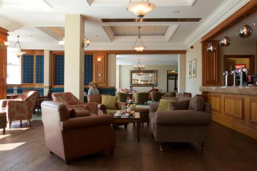 a lobby with couches and chairs and a bar at Carnoustie Golf Hotel 'A Bespoke Hotel’ in Carnoustie