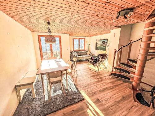 a living room with a table and chairs and a couch at Apartment Casa Foppa by Interhome in Somvix