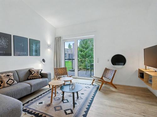 a living room with a couch and a table at Holiday Home Sonnenpfad by Interhome in Lembruch