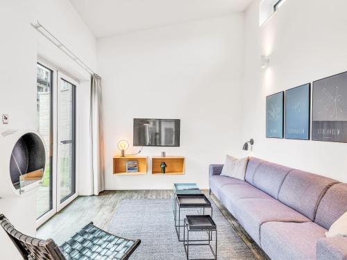 a living room with a couch and a table at Holiday Home Windlicht by Interhome in Lembruch