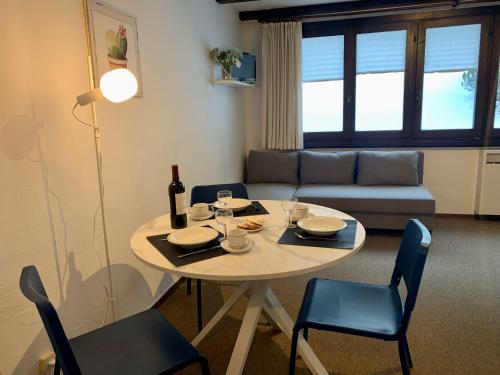 a living room with a table and a couch at Apartment Residenza Chesa Margun 33-1 by Interhome in Surlej
