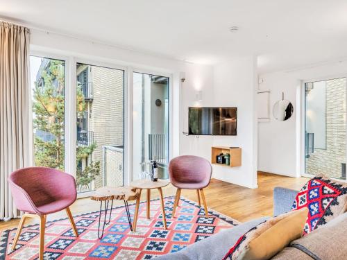 a living room with a couch and two chairs and a table at Apartment Seeidyll by Interhome in Lembruch