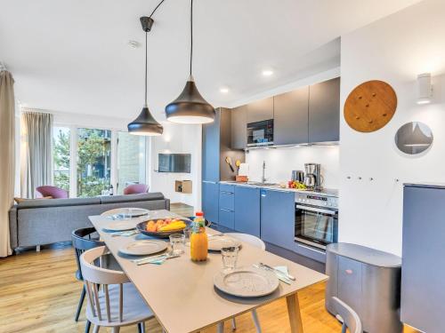a kitchen and dining room with a table and chairs at Apartment Seeidyll by Interhome in Lembruch
