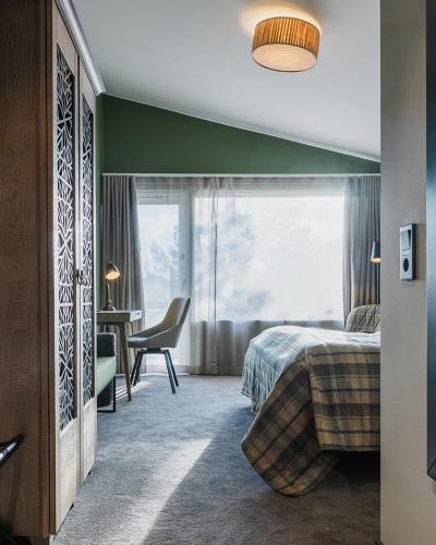 a bedroom with a bed and a window and a desk at Torekov Hotell in Torekov