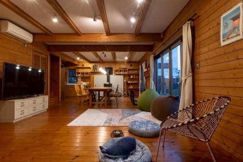 a living room with a television and a table at yado suzuka 1 in Suzuka