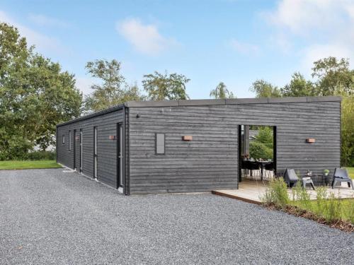 a black tiny house on a gravel driveway at Holiday Home Emelina - 300m from the sea by Interhome in Rude