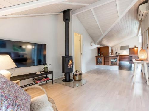 a living room with a wood stove in the middle at Holiday Home Lirim - 400m from the sea by Interhome in Marielyst
