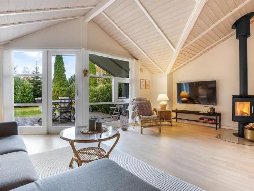 a living room with a couch and a fireplace at Holiday Home Lirim - 400m from the sea by Interhome in Marielyst