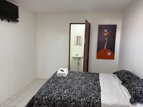 a bedroom with a bed and a sink and a mirror at Hotel la Cruz in Querétaro