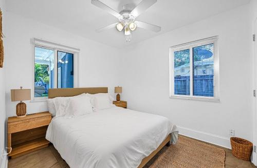 a white bedroom with a bed and a ceiling fan at The Perfect South Florida Experience in Fort Lauderdale