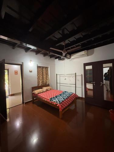 a bedroom with a bed in the middle of a room at Urban Minz in Mūvattupula