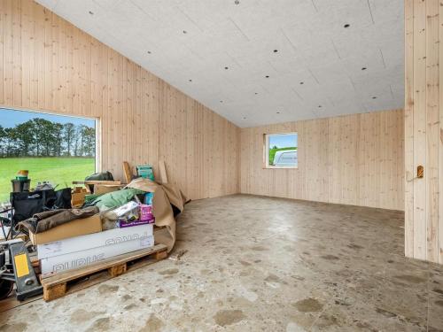 an empty room with a couch and a window at Holiday Home Gillis - 1km from the sea by Interhome in Tvedhuse