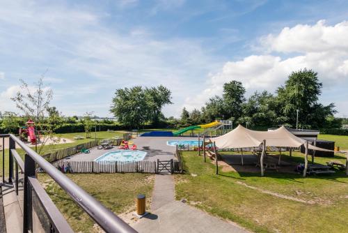 a park with a pool and a playground at Appartement at lake Veluwemeer, nearby Harderwijk, 63km from Amsterdam in Biddinghuizen