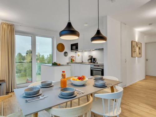a kitchen and dining room with a table and chairs at Apartment Penthouse Seevibes by Interhome in Lembruch